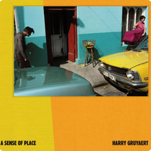 Afbeelding in Gallery-weergave laden, Cover van A Sense of Place van Harry Gruyaert: straatbeeld met een gele auto en een turquoise gevel, op een geel-oranje cover